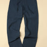 warm medium blue pants on a beige background