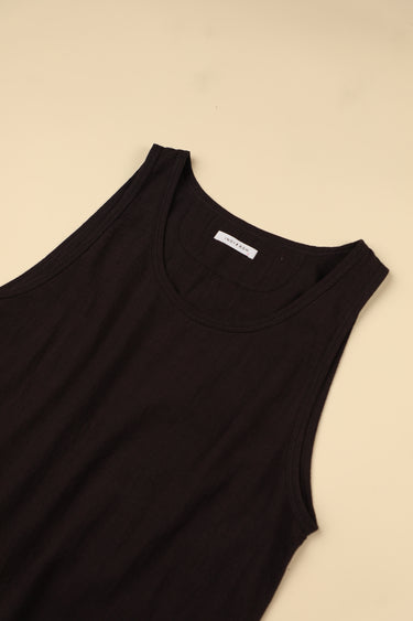 Plum sleeveless top with a brand label on a beige background