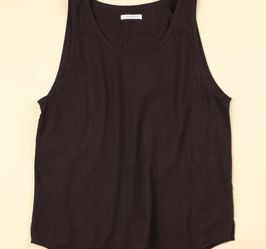 Plum sleeveless shirt on a beige background
