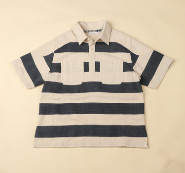 Navy and beige striped polo shirt on a beige background