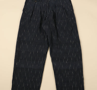 Dark blue pinstripe pants on a beige background