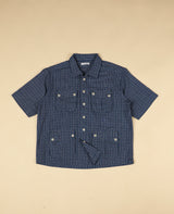 Blue gingham checkered shirt with short sleeves on a beige background