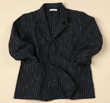 Dark blue pinstripe blazer on a beige background