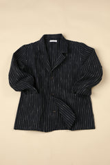 Dark blue pinstripe blazer on a beige background