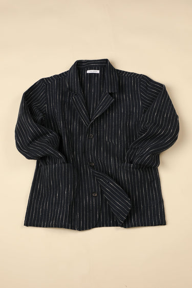 Dark blue pinstripe blazer on a beige background