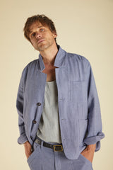 Man wearing a light blue suit with a beige background