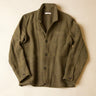 An olive green wool-blend work jacket with a button-up front, laid flat against a light beige background.