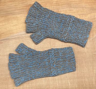 Pair of blue and brown fingerless gloves on a wooden surface