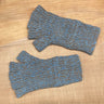 Pair of blue and brown fingerless gloves on a wooden surface